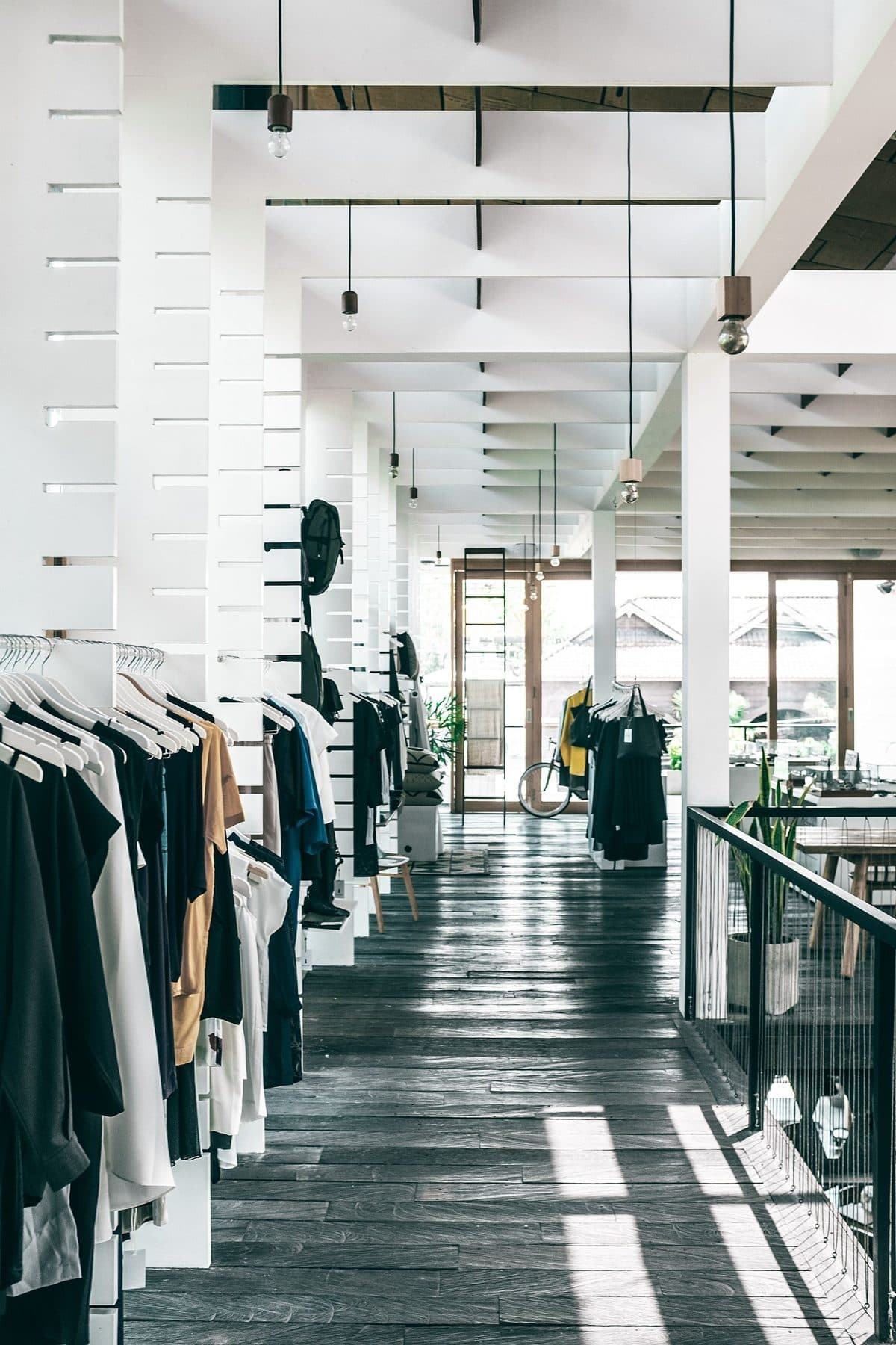 A bright fashion boutique with clothing rails